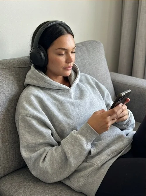 Headphones on, lost in a playlist at home